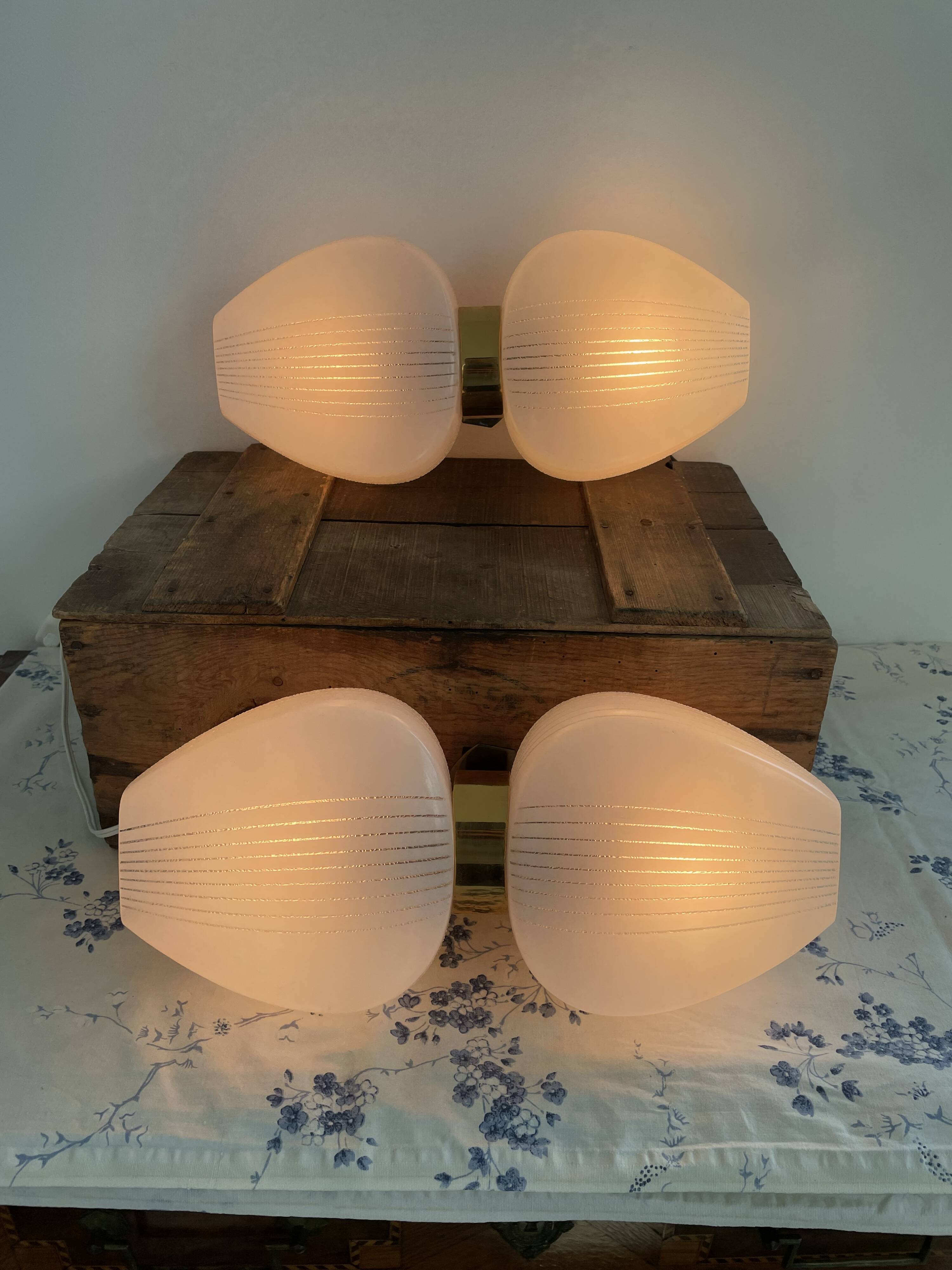 Pair of vintage wall lights from the 60s-70s in striped opaline glass and gilded brass.