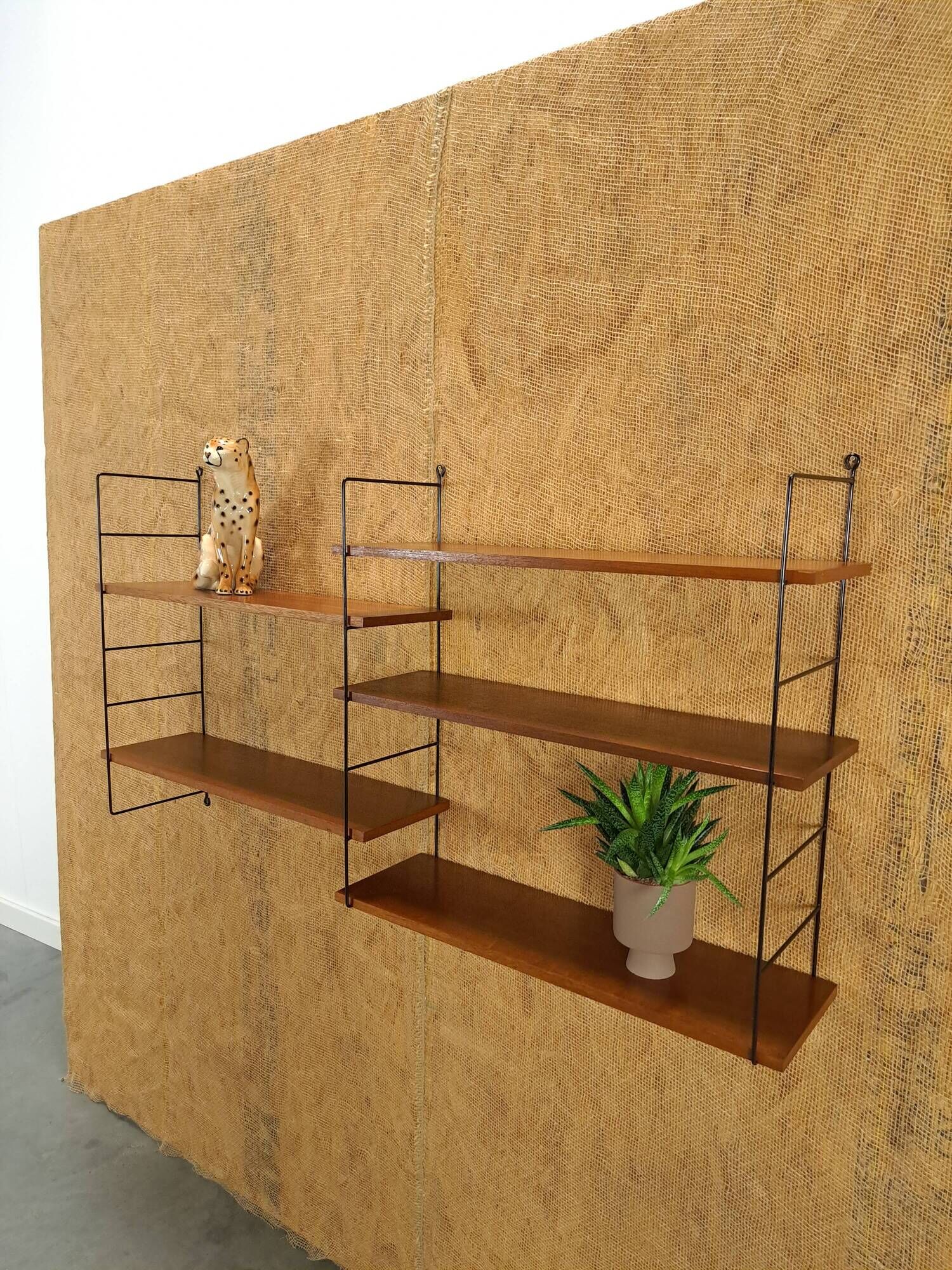 Wall rack with shelves and steel holders, dark wall system