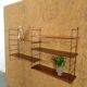 Wall rack with shelves and steel holders, dark wall system