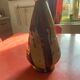 Large antique pottery bottle in glazed terracotta with drips.