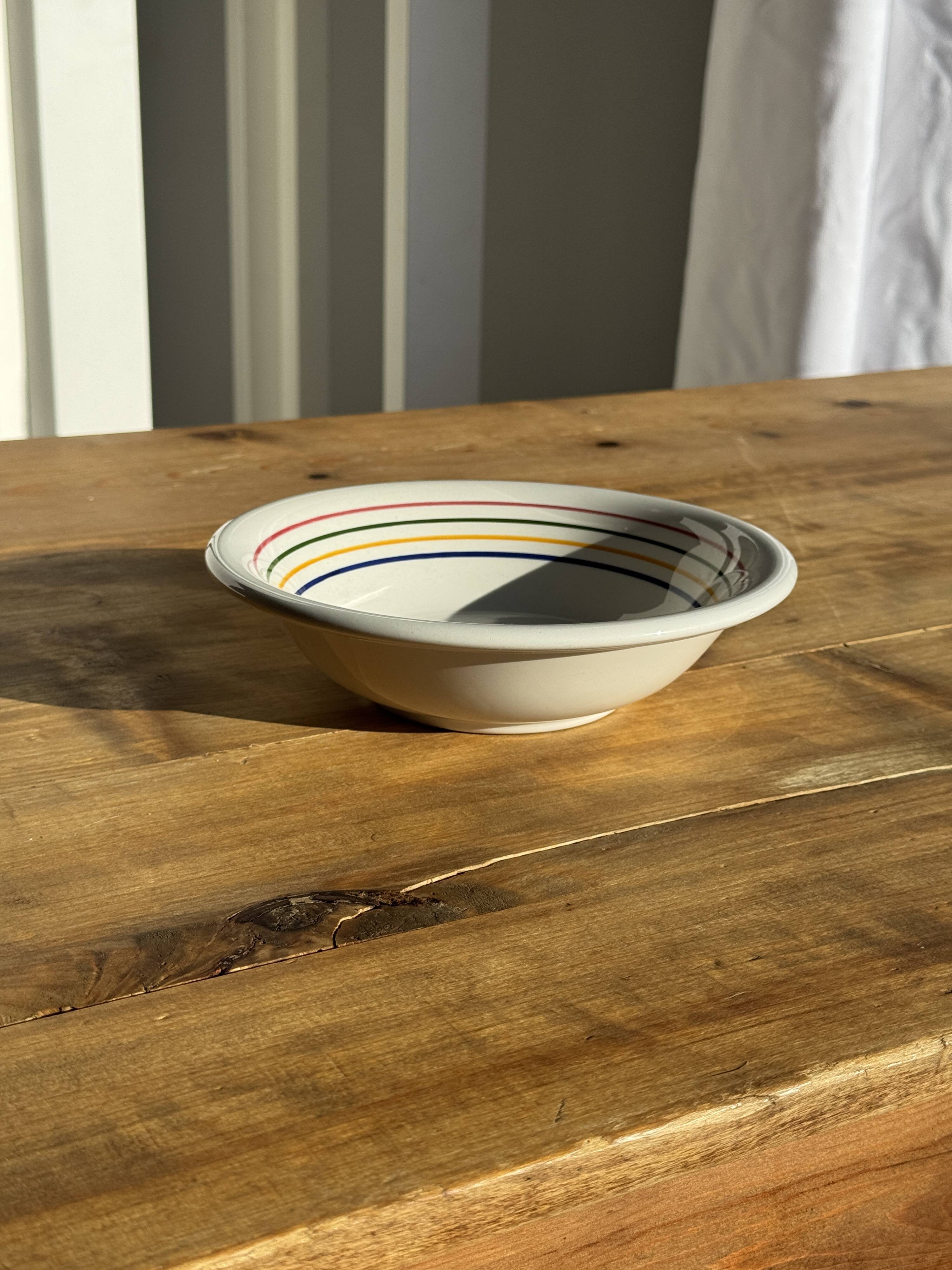 Small earthenware bowl from Italy, white with brown, green, and orange trim, D24.5.