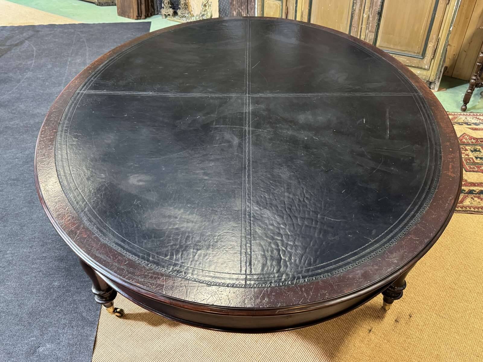 Large English library table in dark walnut with a leather top.