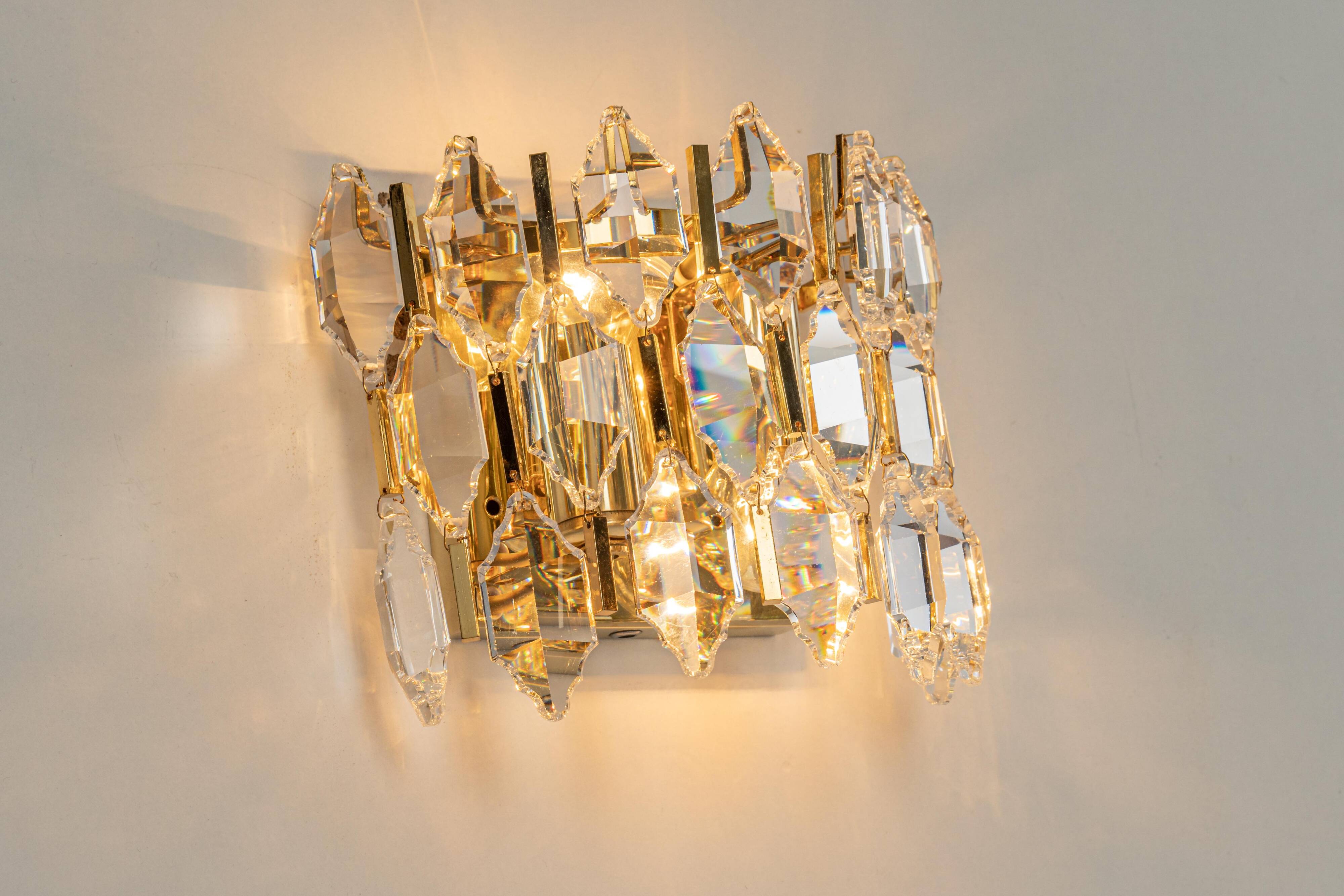 Pair of wall sconces in gilded brass and crystal by Palwa, Germany, 1970s.