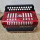Red Aidi R accordion in his suitcase