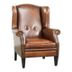 Sheepskin wingback armchair finished with black piping and a correct seat