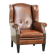 Sheepskin wingback armchair finished with black piping and a correct seat