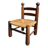 Brutalist low chair in dark wood and straw no. 1