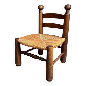 Brutalist low chair in dark wood and straw no. 1