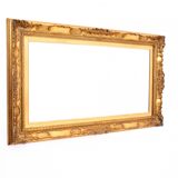 A mirror with a golden, richly carved frame.