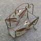 Vintage wrought iron magazine rack with flower pattern.