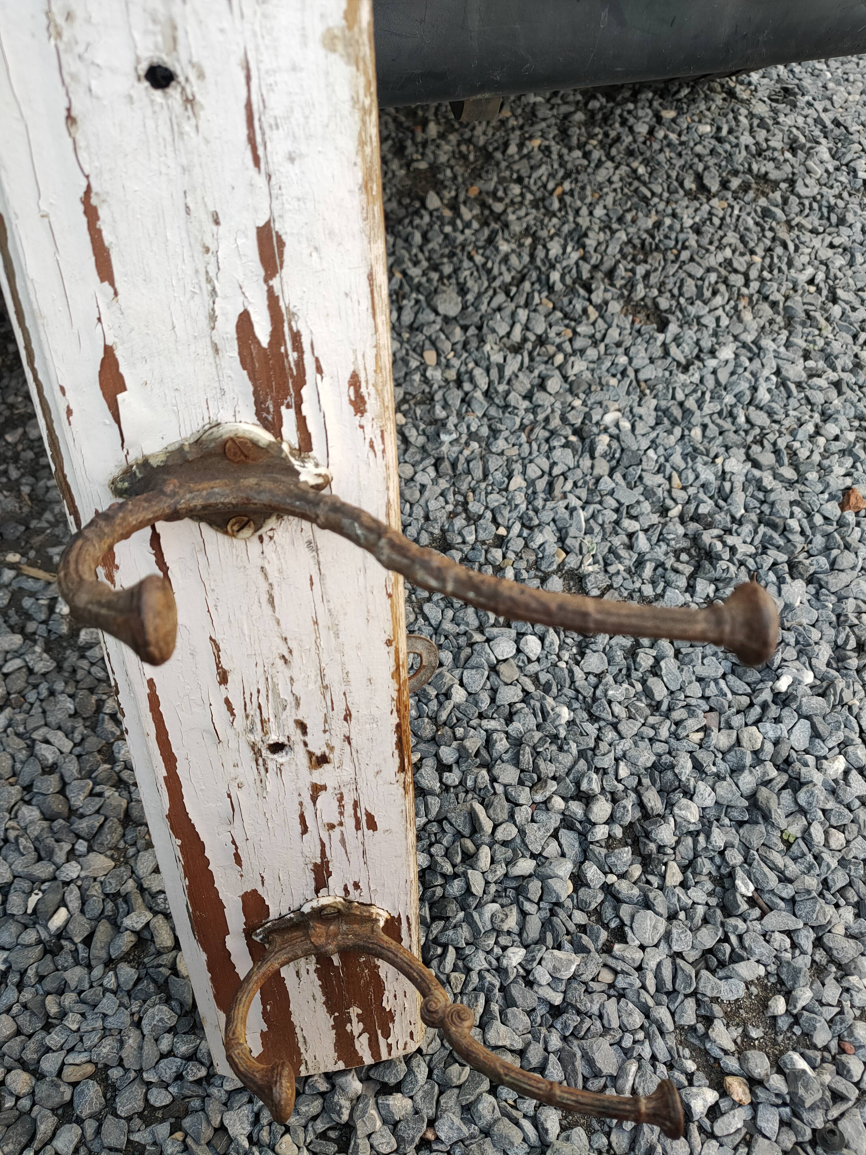 antique coat rack with 4 cast iron hooks