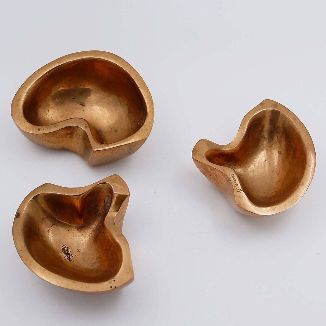 Empty Pockets in polished bronze Margrit van Nuffel 1970, set of 3