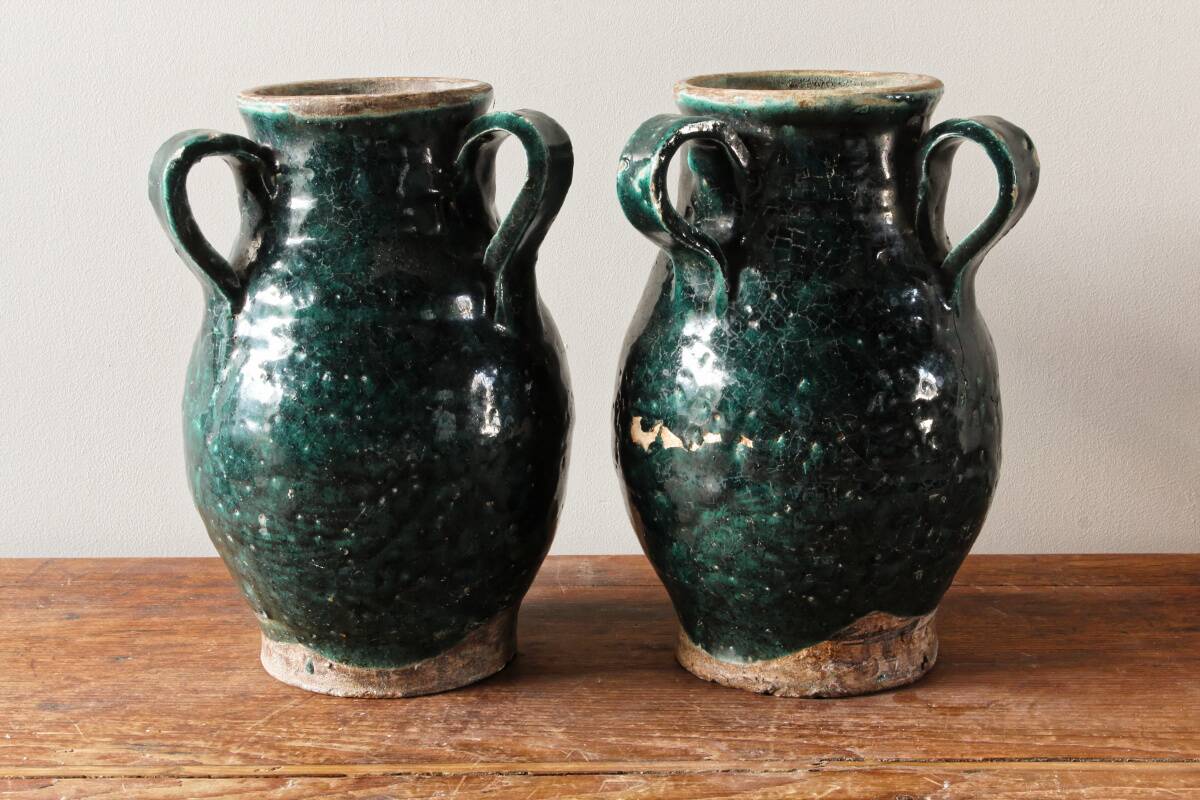 Set of two Chinese green glazed stoneware storage jars.