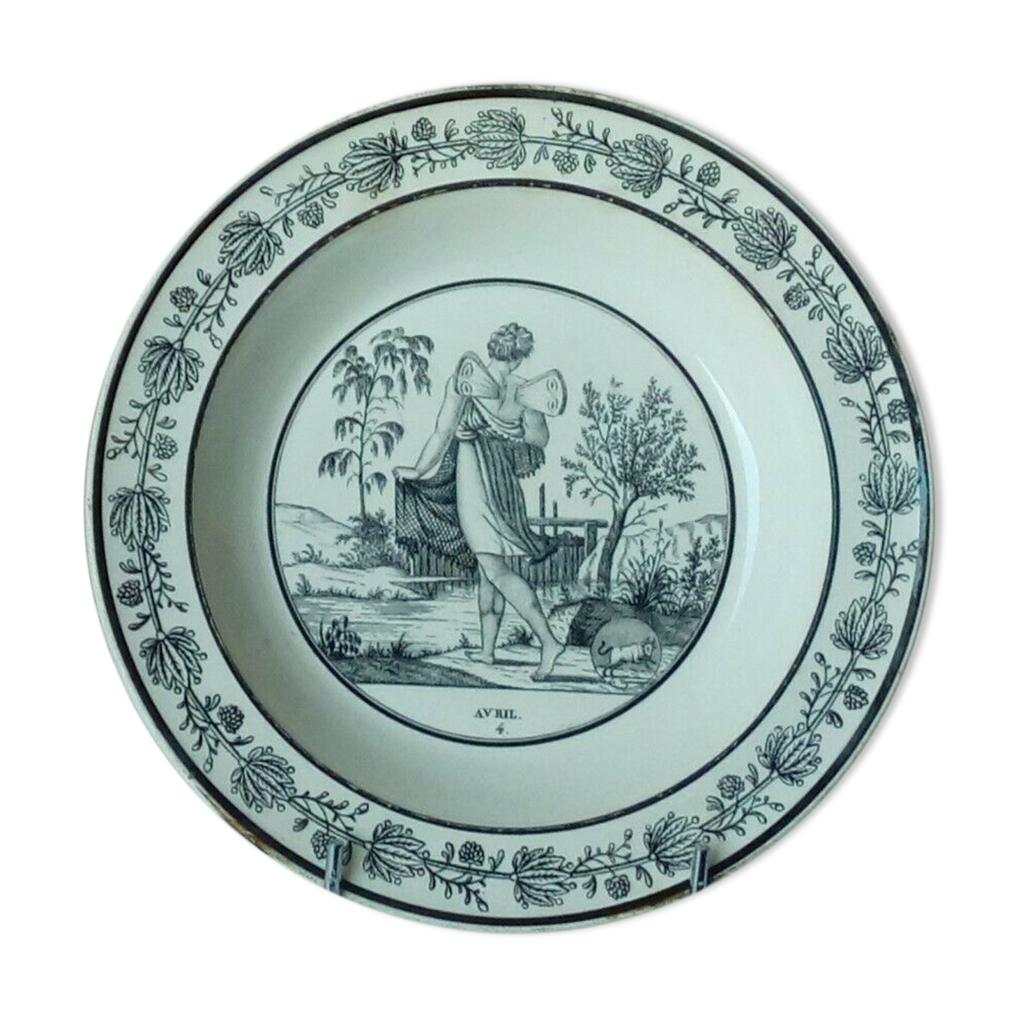 CHOISY HOLLOW PLATE IN FINE FAIENCE ON THE THEME OF THE MONTHS "APRIL"