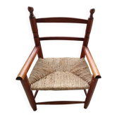 Children's wooden armchair and straw-covered seat.