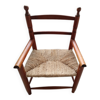 Children's wooden armchair and straw-covered seat.