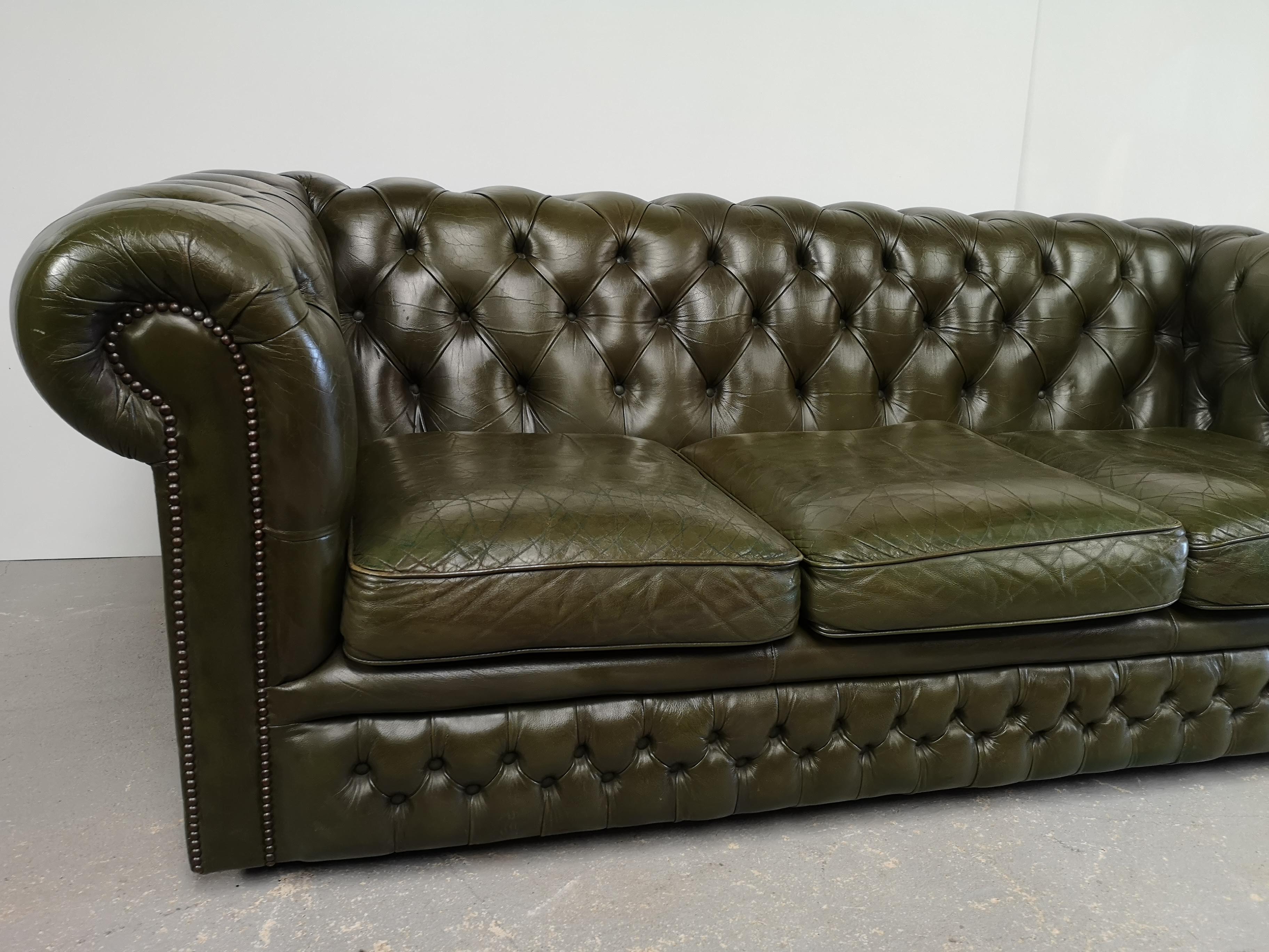 Three-seater green leather Chesterfield sofa
