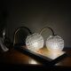 Large pair of brass swan neck wall lights with transparent glass globes.