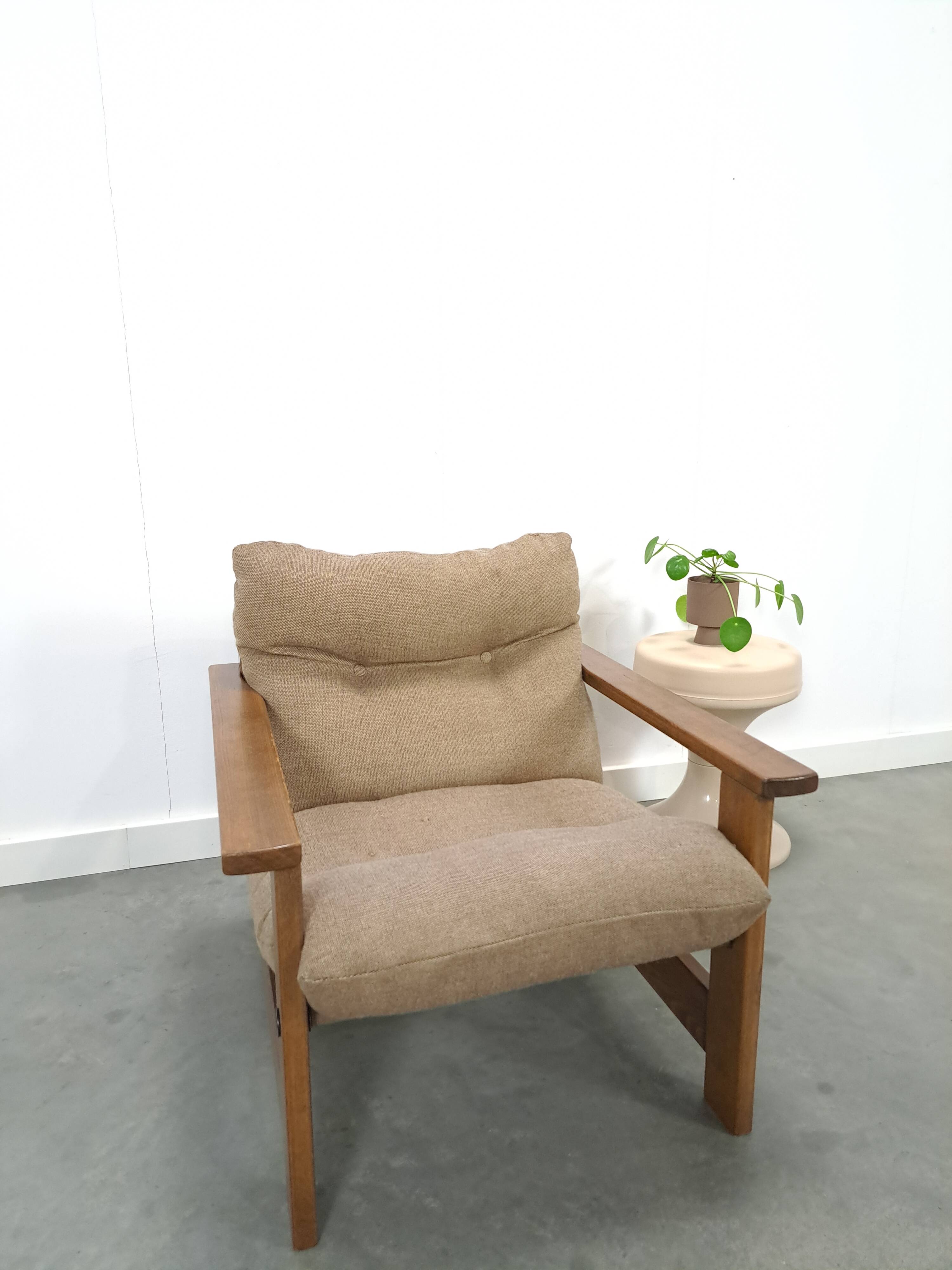 Brown-grey armchair with an oak frame.