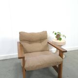 Brown-grey armchair with an oak frame.