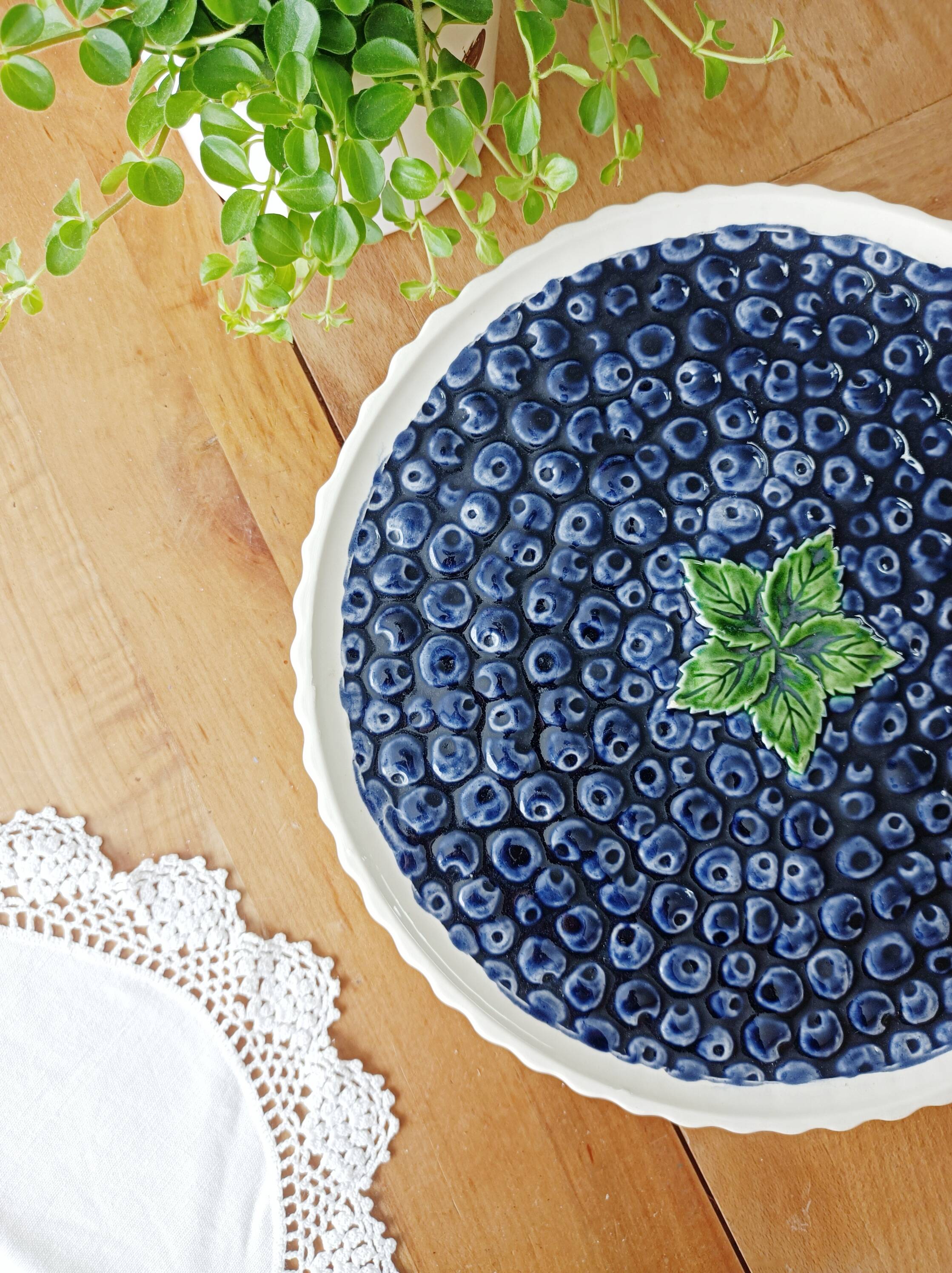 Pie dish on foot, in slip with blackberry decoration