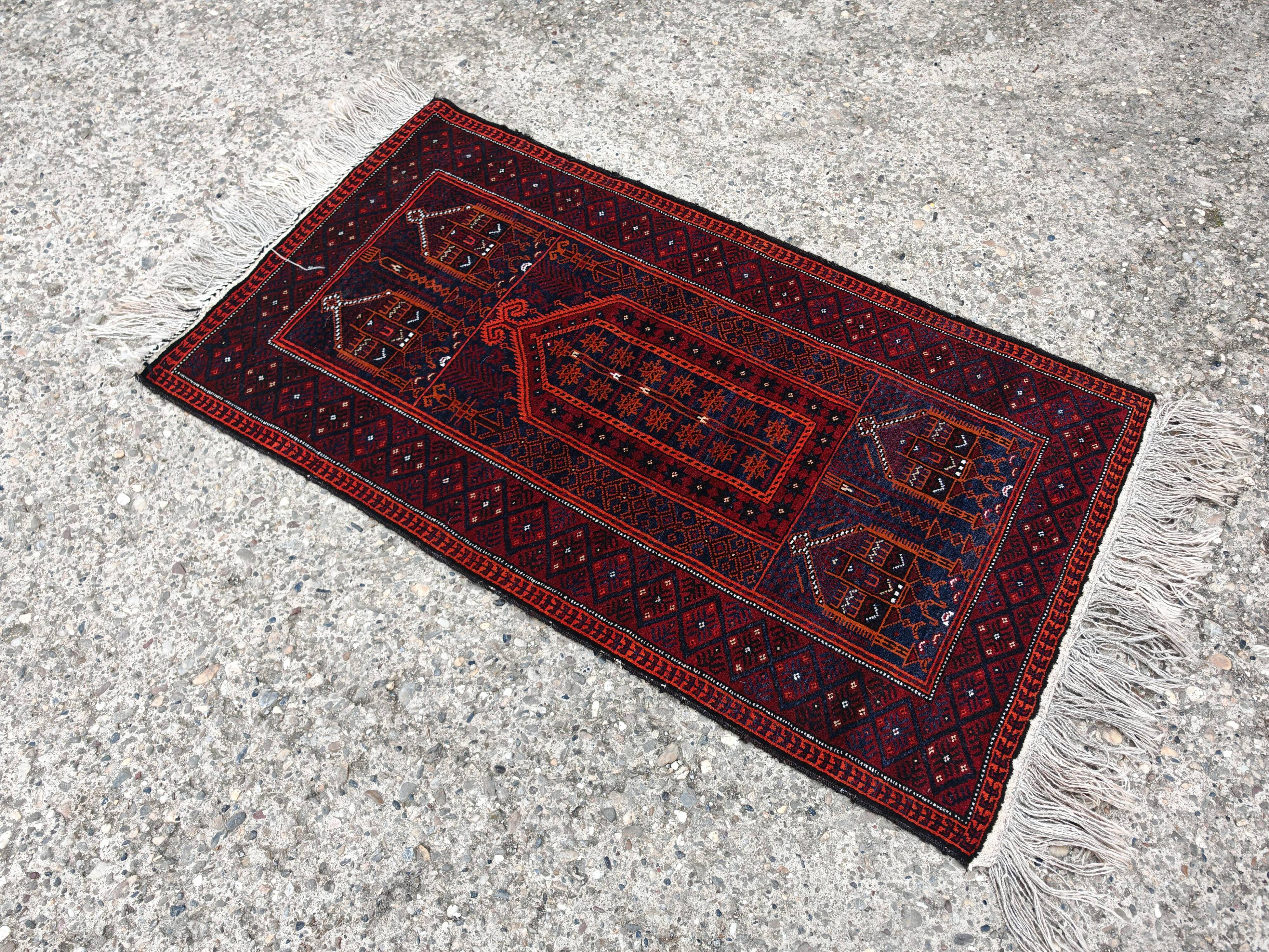 Vintage hand-knotted Persian Baluch prayer rug from the 1940s.