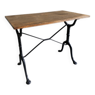 Vintage bistro table with black lacquered cast iron base and solid wood top 90 x 52 cm