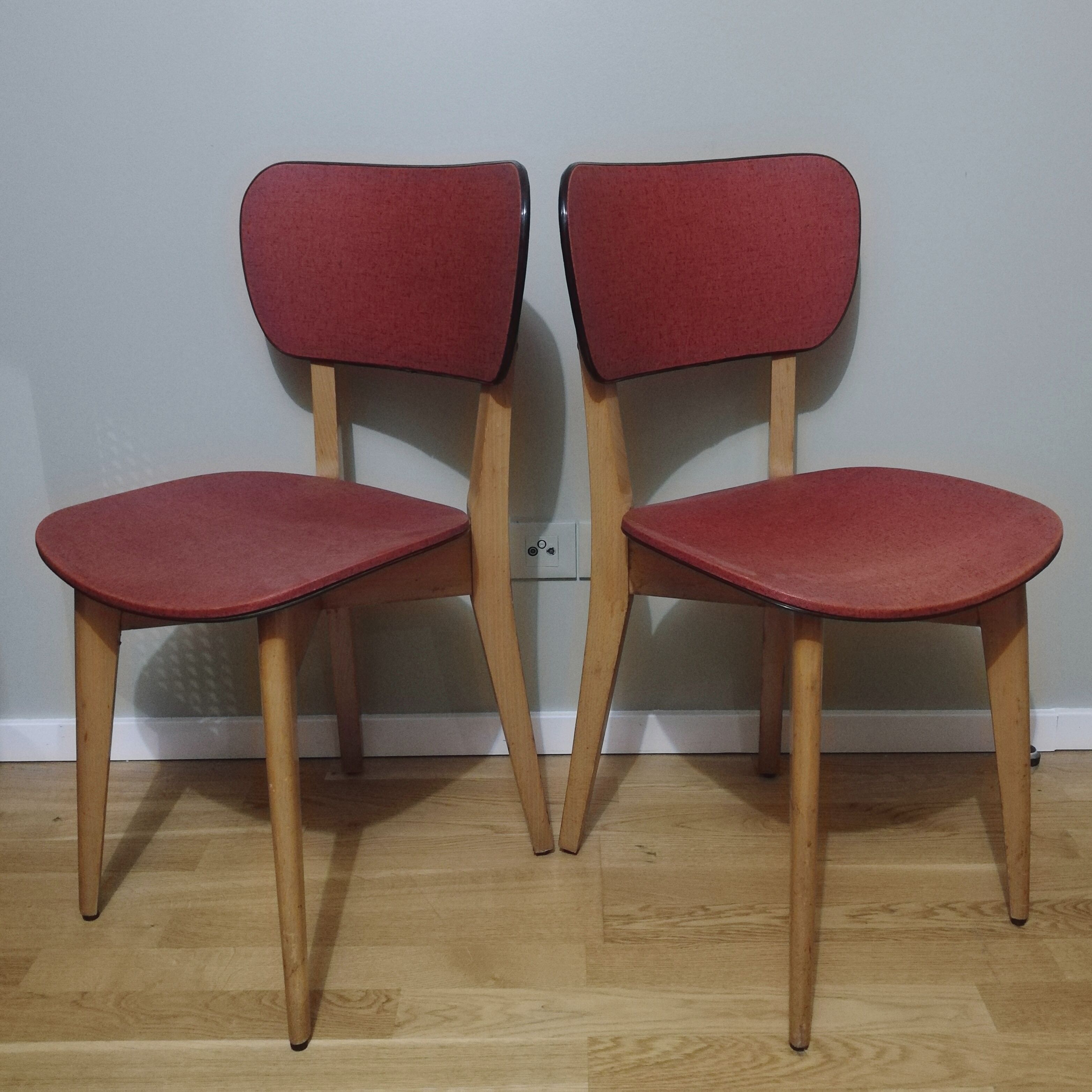 Two vintage chairs wood and mottled red vinyl