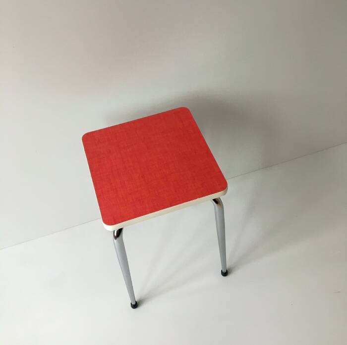 Stool in pinkish red formica