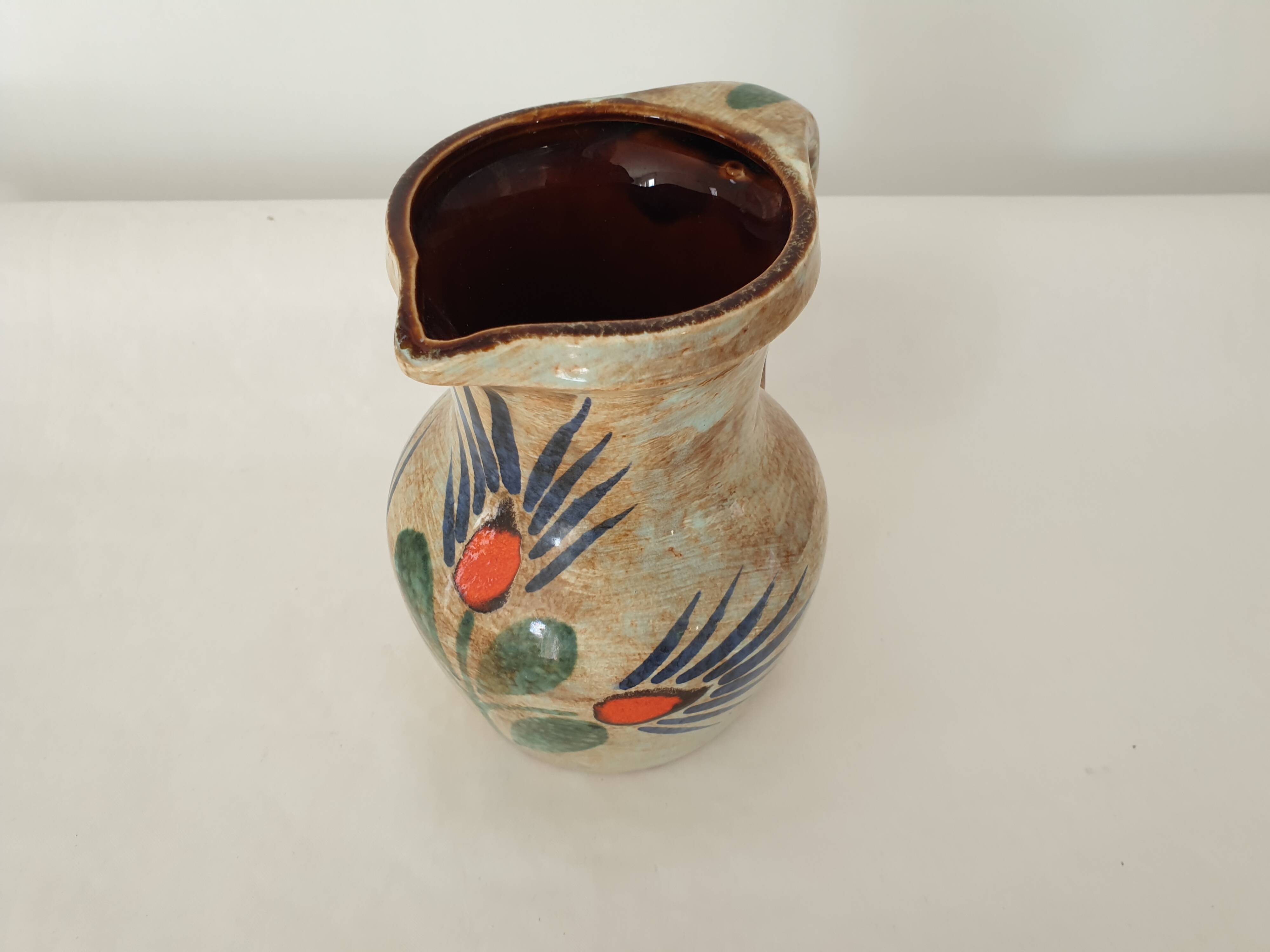 Ceramic pitcher with floral motif signed Saint Clément
