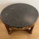 Empire gueridon in mahogany veneer adorned with chiselled and gilded bronze, topped with black marble with a groove.