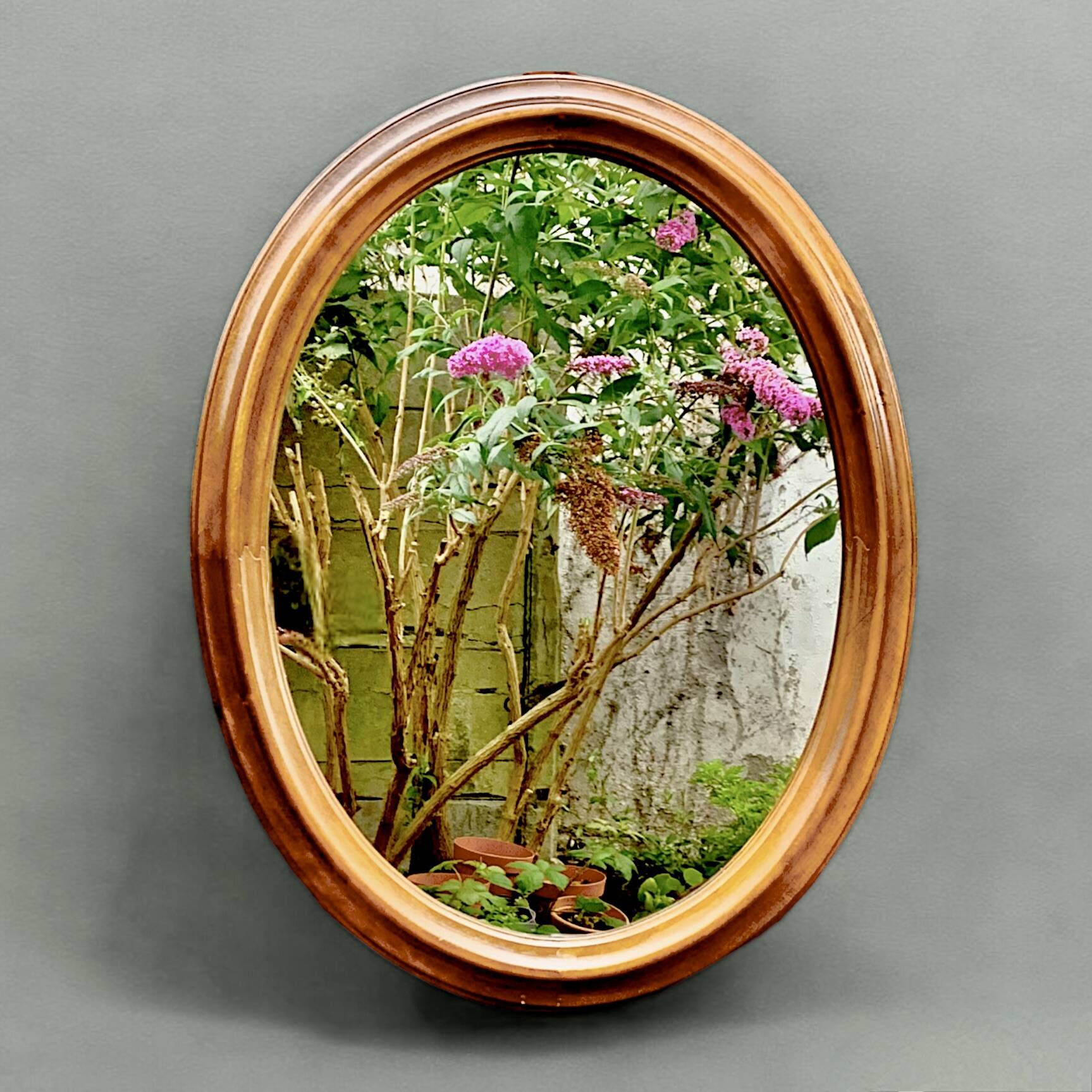 Old large oval wooden wall mirror