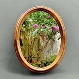 Old large oval wooden wall mirror