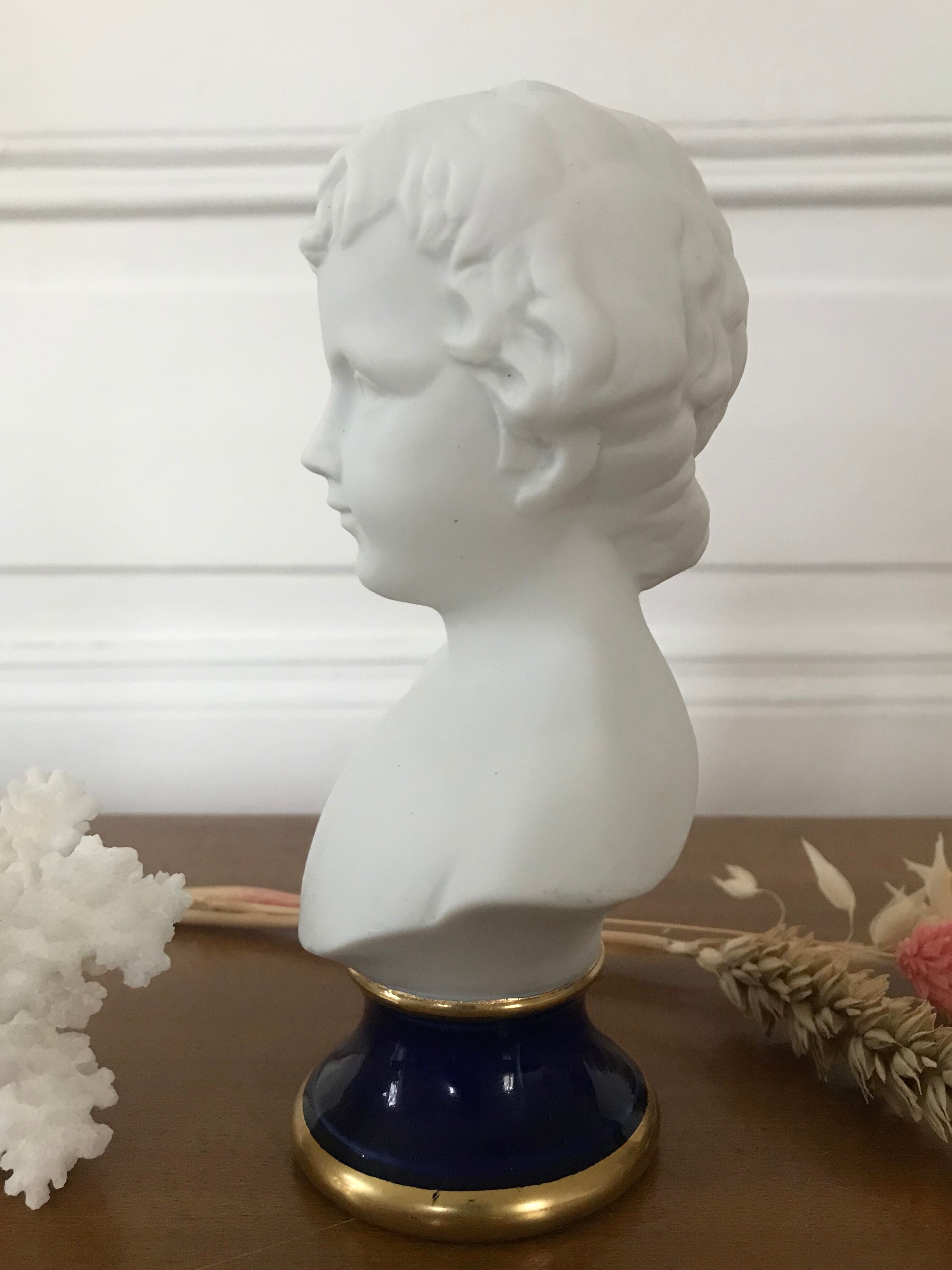 Ancient statuette bust in biscuit