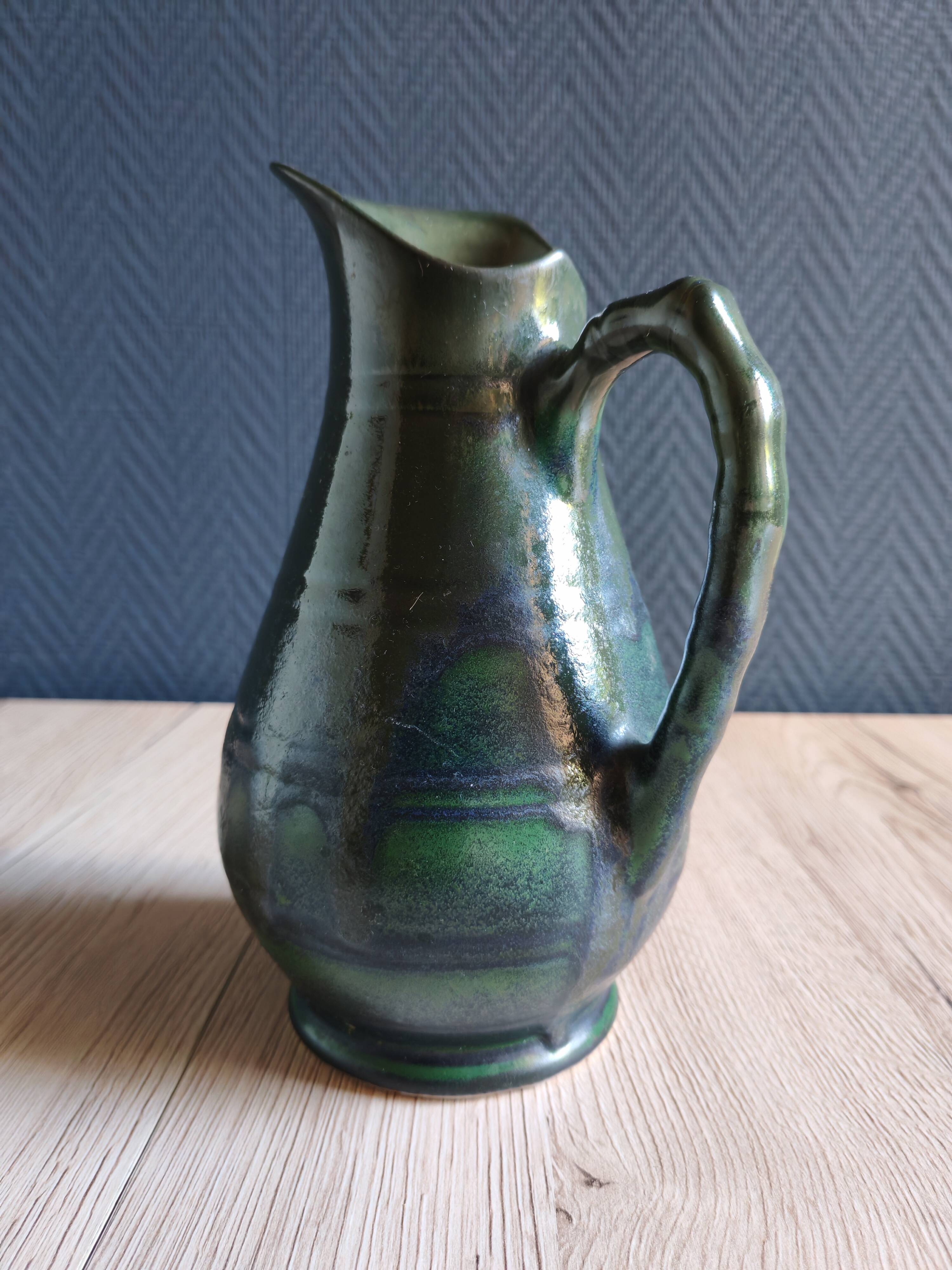 Vintage ceramic pitcher vase in glazed green and blue.