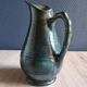 Vintage ceramic pitcher vase in glazed green and blue.