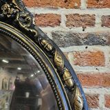 Ancien miroir ovale patiné noir et doré style louis xv