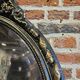 Old black and gold patinated oval mirror louis xv style
