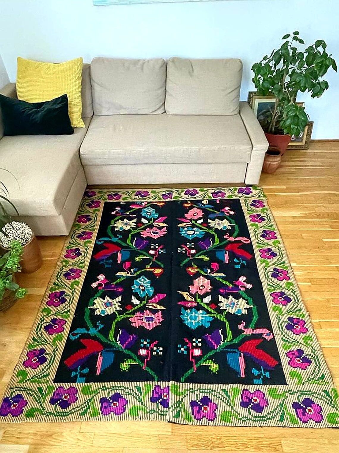 Romanian wool carpet floral design with green border on black background 180x153cm