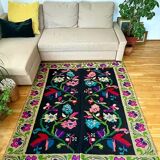 Romanian wool carpet floral design with green border on black background 180x153cm