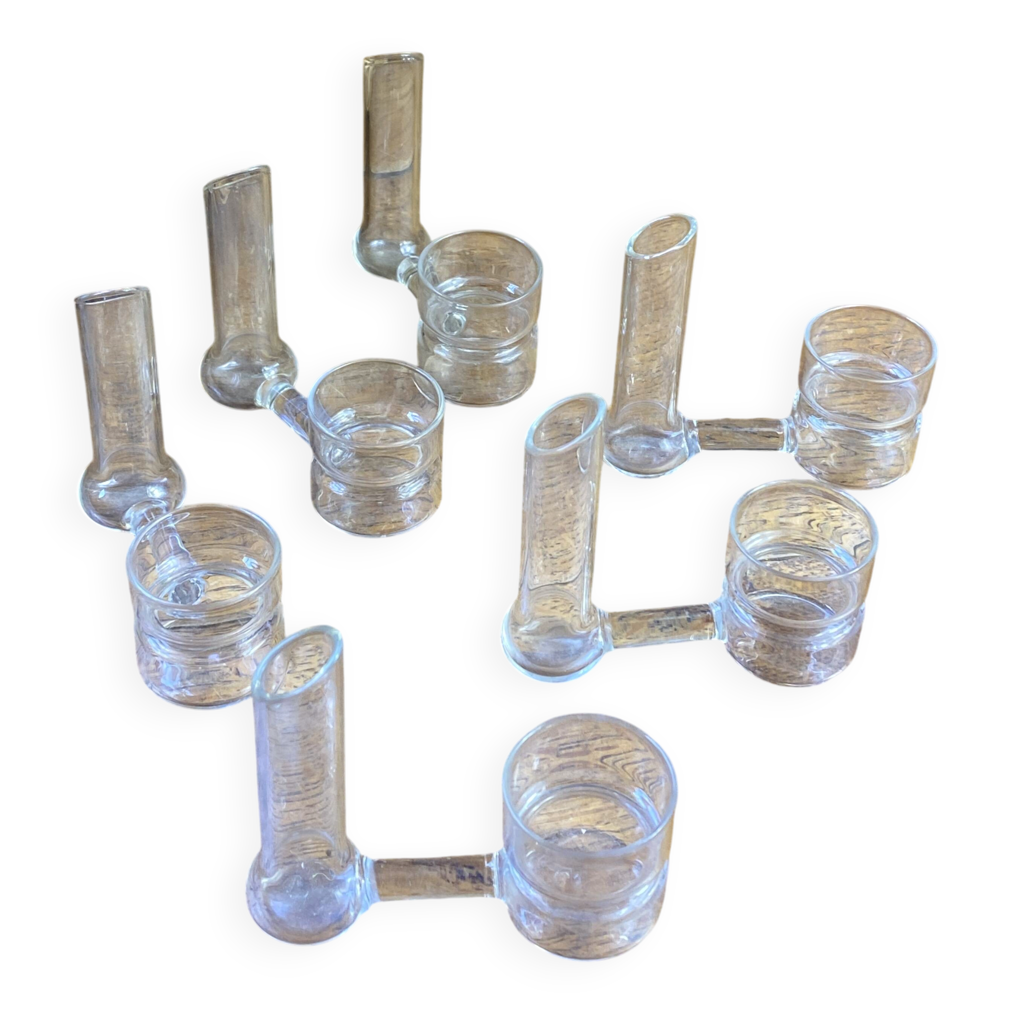 Knife rests, flower vases and candle holders in blown glass.
