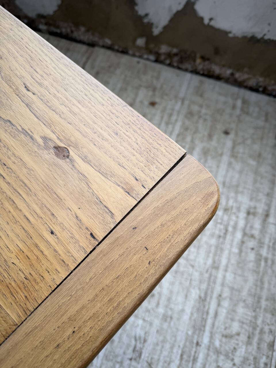 Oak farmhouse table with turned black legs.