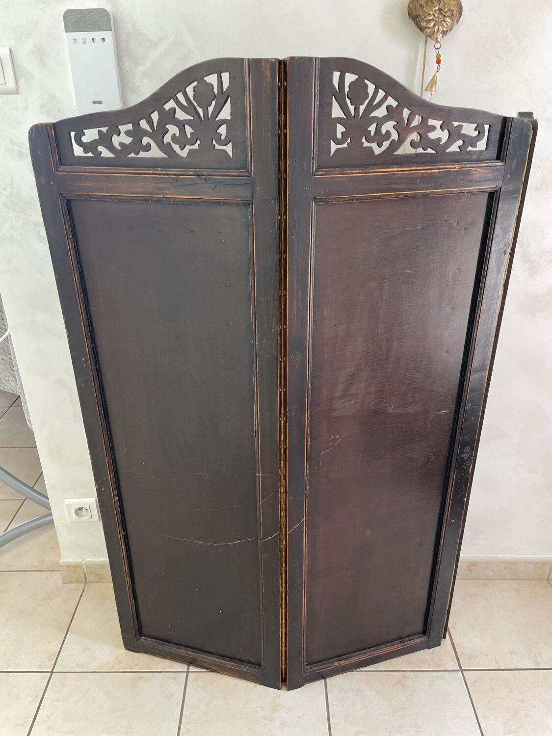 Antique wooden wall panel with carving and cane in an Asian style.