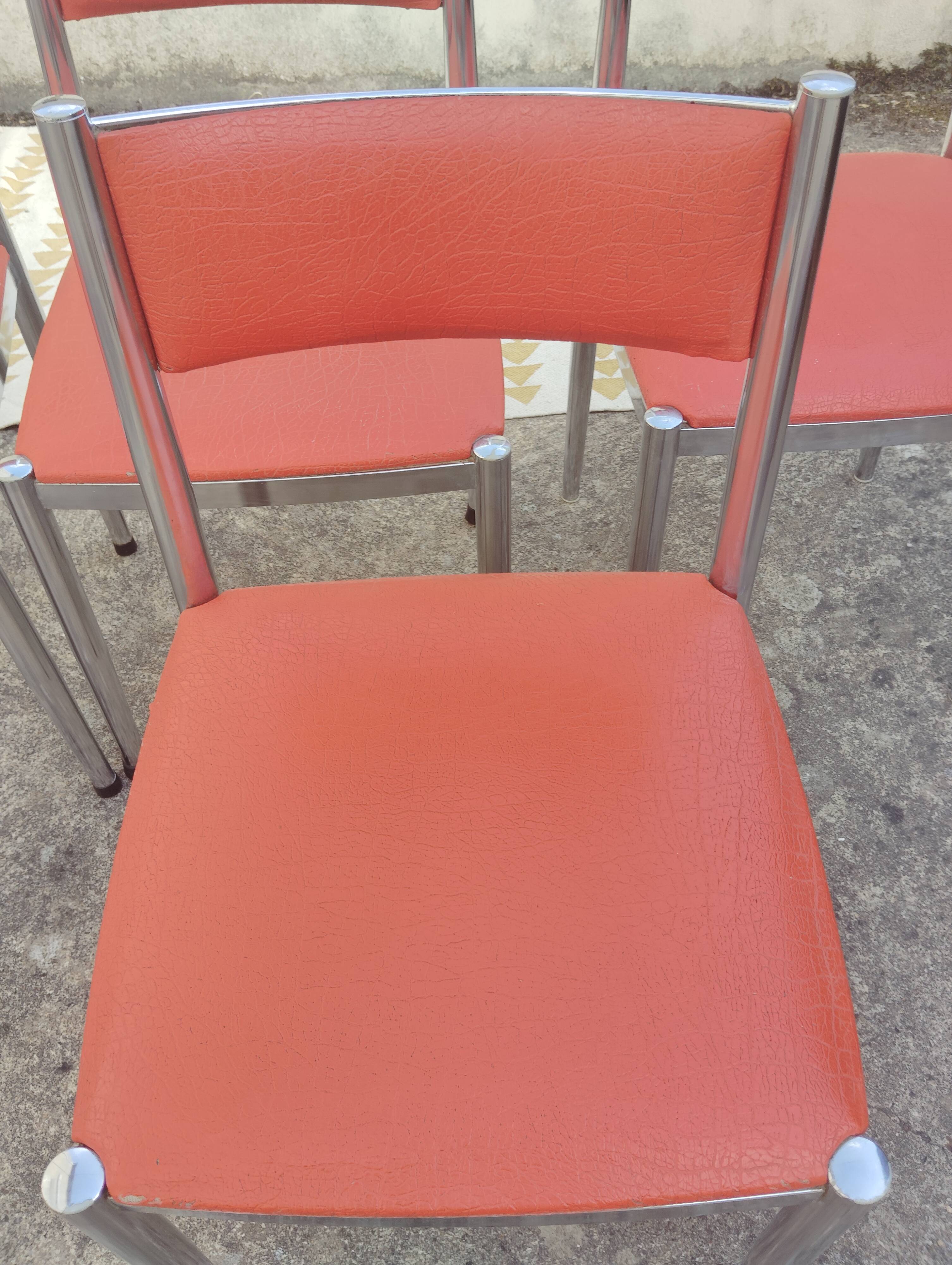 Set of 4 vintage chrome and orange faux leather chairs.