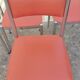 Set of 4 vintage chrome and orange faux leather chairs.