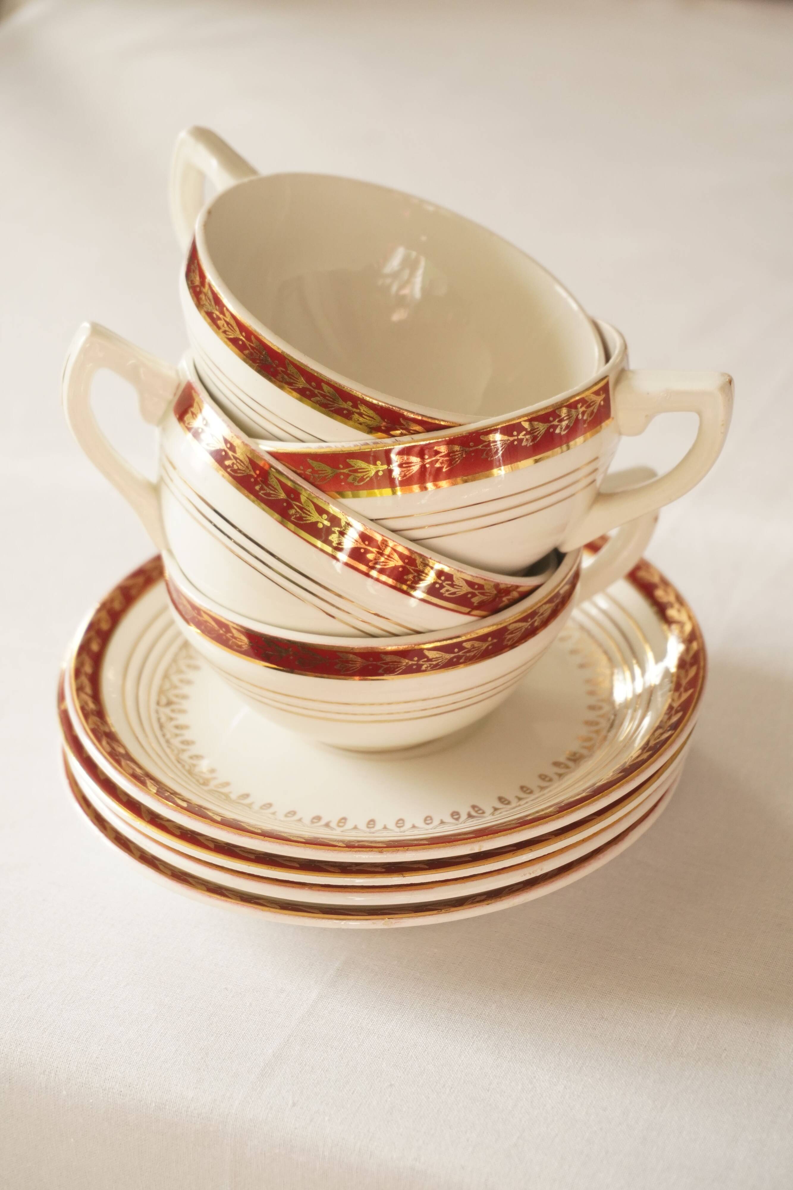 Set of 4 white, red and gold porcelain teacups, Ceranord