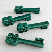 4 green ceramic knife rests in vintage key shape