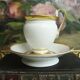 Tasse et soucoupe ancienne en porcelaine blanche et or XIXème avec poignée forme tête de cygne