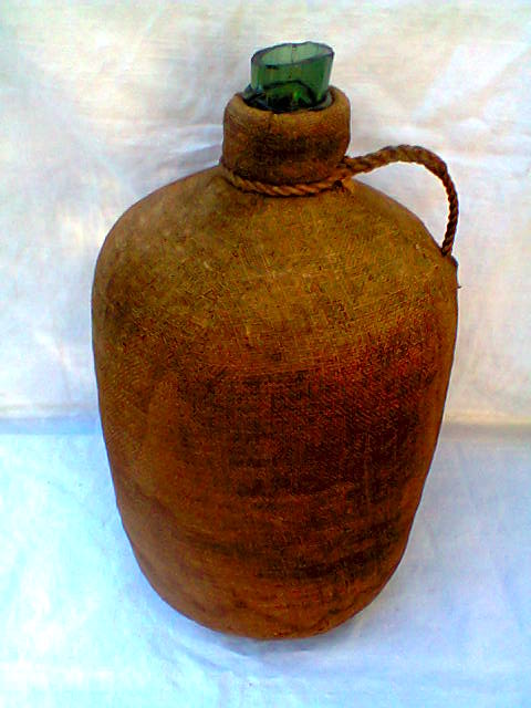Demijohn dressed in burlap and padded cork