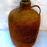 Demijohn dressed in burlap and padded cork